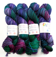 Load image into Gallery viewer, Four skeins of multicolored yarn with visible brand labels on a white background
