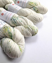 Load image into Gallery viewer, White yarn with green speckles on a white background
