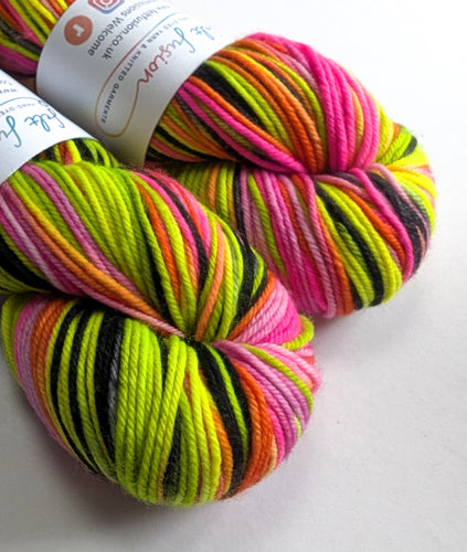 Multicolored yarn skein with a brand label on a white background