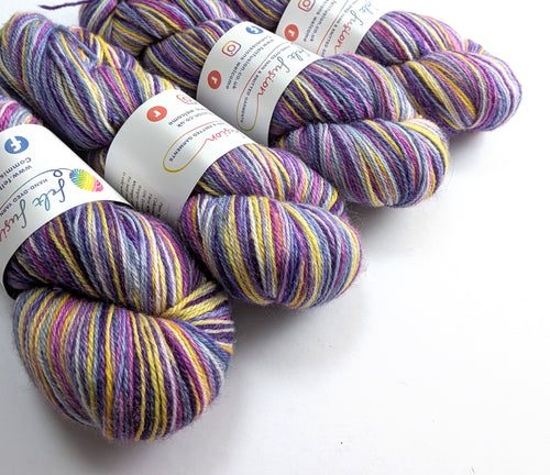 Multicolored yarn skeins with labels on a white background