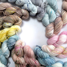 Load image into Gallery viewer, A set of pastel and speckled mini skeins arranged in a circle.
