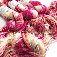 Load image into Gallery viewer, Close-up of pink and white yarn skeins on a white background
