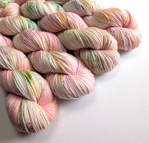 Pastel-colored yarn skeins on a white background