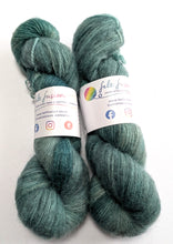Load image into Gallery viewer, Two skeins of green yarn with labels on a white background
