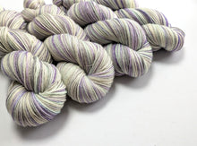 Load image into Gallery viewer, Purple and white striped yarn skeins on a white background

