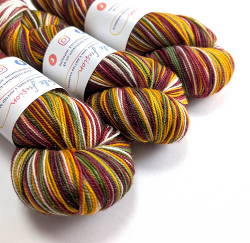 Multicolored yarn skeins with labels on a white background