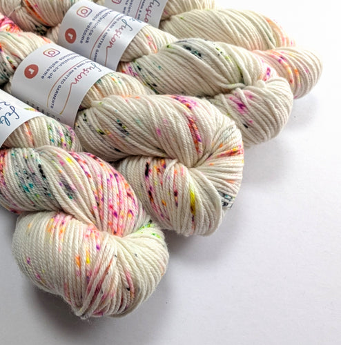Spotted yarn skeins with labels on a white background