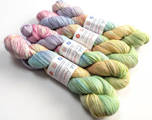 Load image into Gallery viewer, Pastel-colored yarn skeins with labels on a white background
