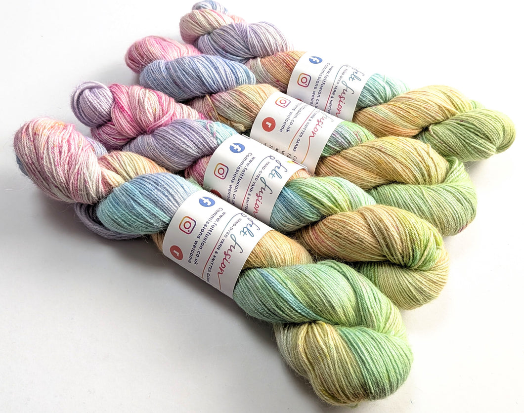 Pastel-colored yarn skeins with labels on a white background