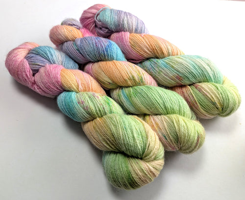 Pastel coloured yarn on a white background.