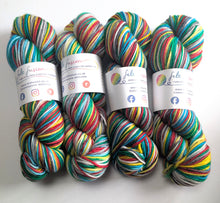 Load image into Gallery viewer, Four skeins of multicoloured yarn with visible brand labels on a white background

