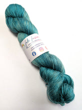 Load image into Gallery viewer, Turquoise skein of yarn with a label on a white background
