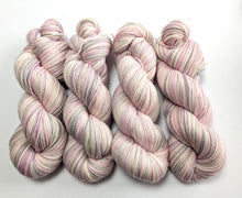 Load image into Gallery viewer, Set of pink and white skeins of yarn on a white background
