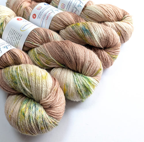 Four skeins of multicolored yarn on a white background