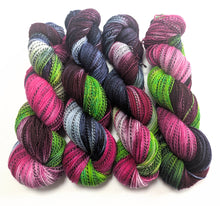 Load image into Gallery viewer, Colorful skeins of yarn in various shades on a white background
