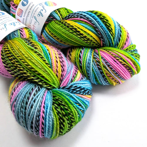 Colorful skeins of yarn with a brand label on a white background