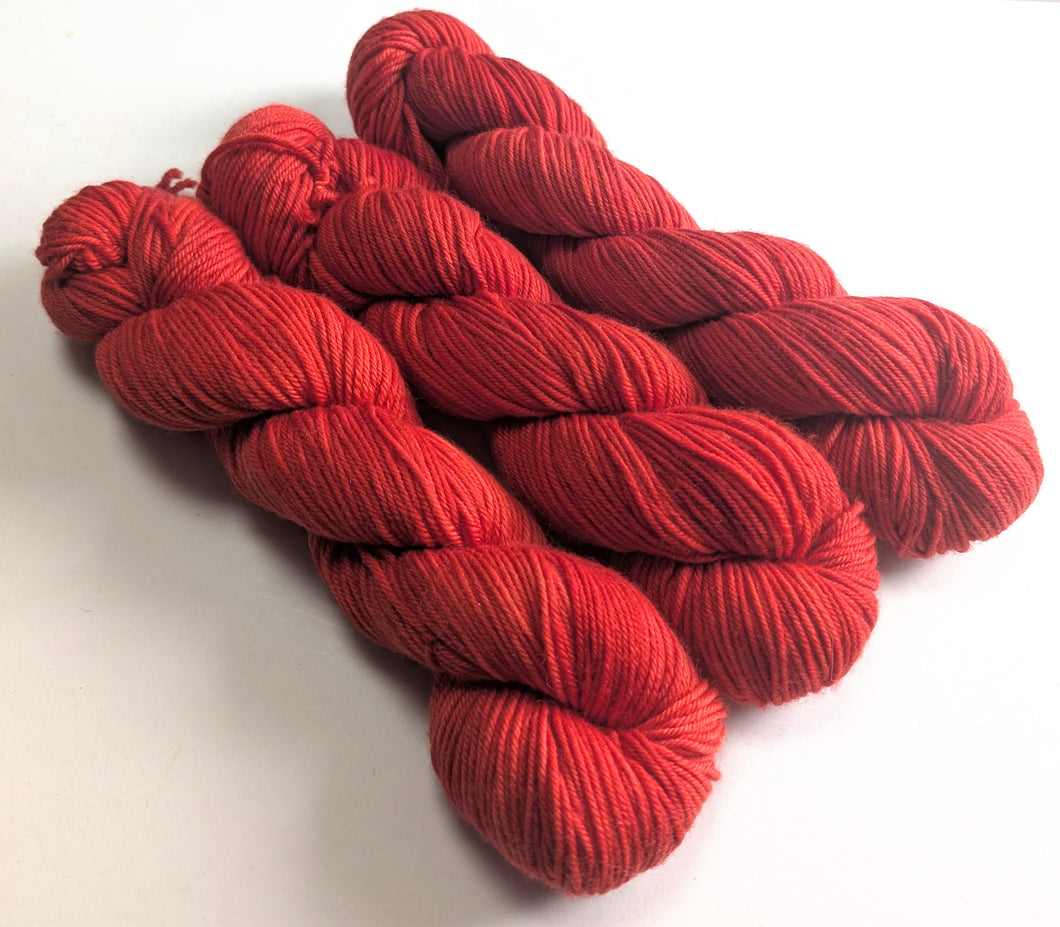 Red yarn skeins on a white background
