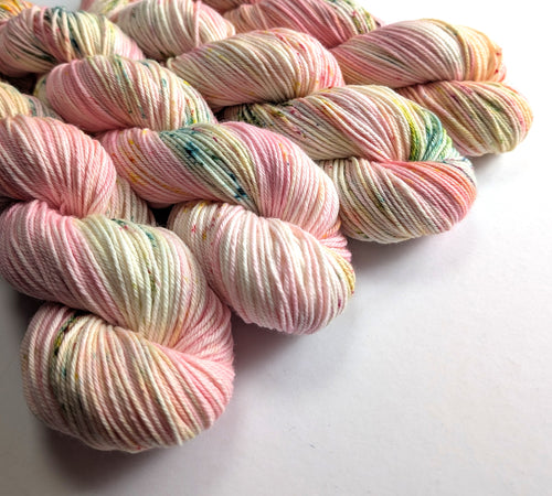 Pastel multicolor yarn skeins on a white background