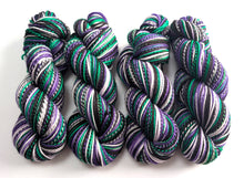 Load image into Gallery viewer, Colorful skeins of yarn on a white background
