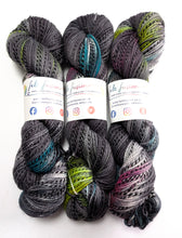 Load image into Gallery viewer, Three skeins of multicolored yarn with visible brand labels on a white background
