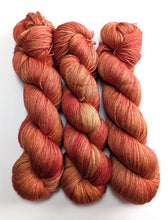 Load image into Gallery viewer, Three skeins of orange and red yarn on a white background
