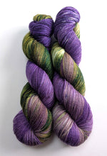 Load image into Gallery viewer, Two skeins of purple and green yarn on a white background
