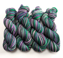 Load image into Gallery viewer, Green and purple skeins of yarn on a white background
