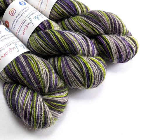 skeins of multicolored yarn with labels on a white background