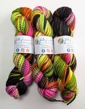 Load image into Gallery viewer, Three skeins of colorful yarn with labels on a white background
