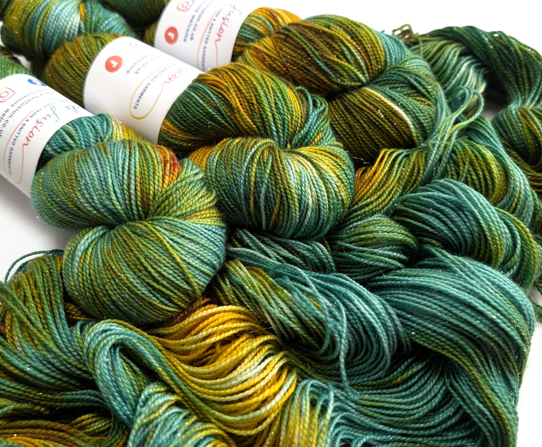 Green and yellow skeins of yarn with labels on a white background