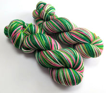 Load image into Gallery viewer, Colorful yarn skeins with green, pink, and white on a white background
