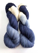 Load image into Gallery viewer, Two skeins of yarn with a gradient from blue to white on a white background
