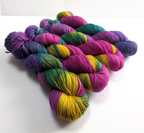 Colorful skeins of yarn on a white background