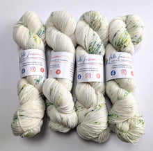 Load image into Gallery viewer, Four skeins of yarn with labels on a white background
