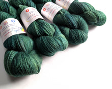 Load image into Gallery viewer, Green yarn skeins with labels on a white background
