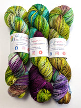 Load image into Gallery viewer, Colorful yarn skeins with visible branding on a white background
