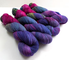 Load image into Gallery viewer, Multicolored yarn skeins on a white background
