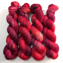 Load image into Gallery viewer, Red, purple and pink yarn skeins on a white background
