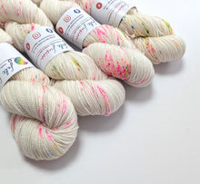 Load image into Gallery viewer, Snot Cake on a superwash Merino/nylon/sparkle sock yarn.
