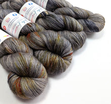 Load image into Gallery viewer, Four skeins of multicolored yarn with labels on a white background
