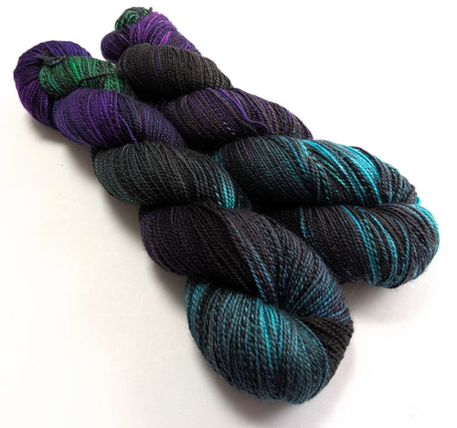 Two skeins of multicolored yarn on a white background