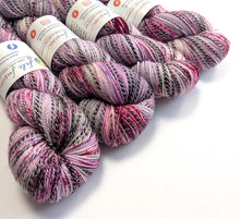 Load image into Gallery viewer, Multicolored yarn skeins with labels on a white background
