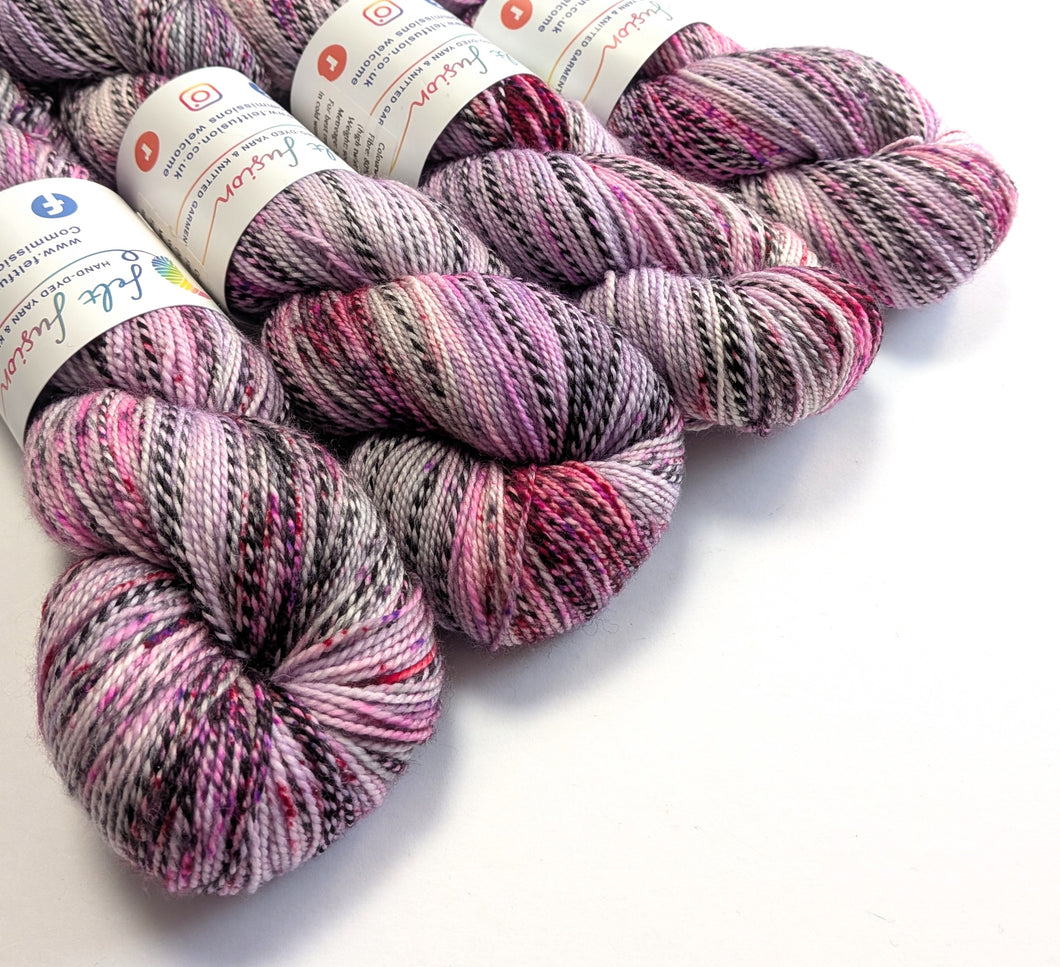 Multicolored yarn skeins with labels on a white background