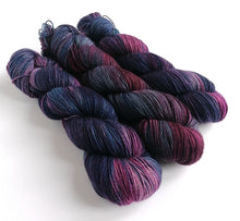 Load image into Gallery viewer, 3 twisted skeins in dark purples and blues, on a white background.
