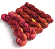 Load image into Gallery viewer, Pinks and Reds gradient yarn set on superwash merino/nylon/sparkle sock yarn.
