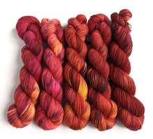 Load image into Gallery viewer, Pinks and Reds gradient yarn set on superwash merino/nylon/sparkle sock yarn.
