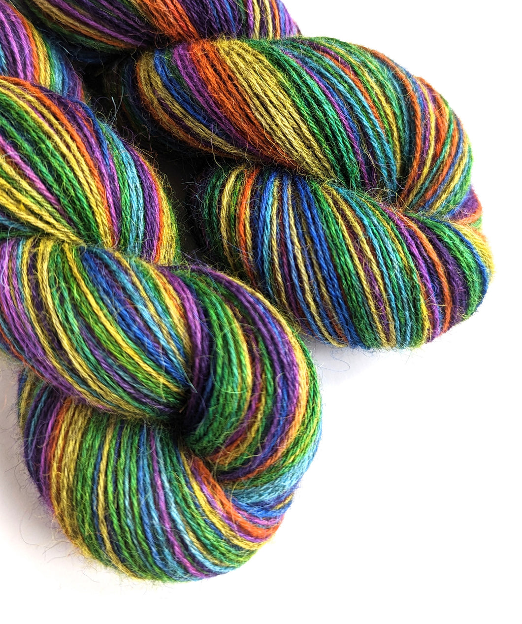 Wintertime Rainbow on 100% llama 4ply/fingering weight yarn. Grey base.