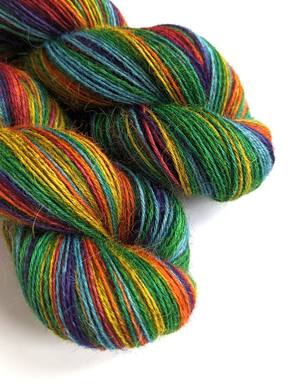 Rainbow on 100% llama 4ply/fingering weight yarn. Grey base.