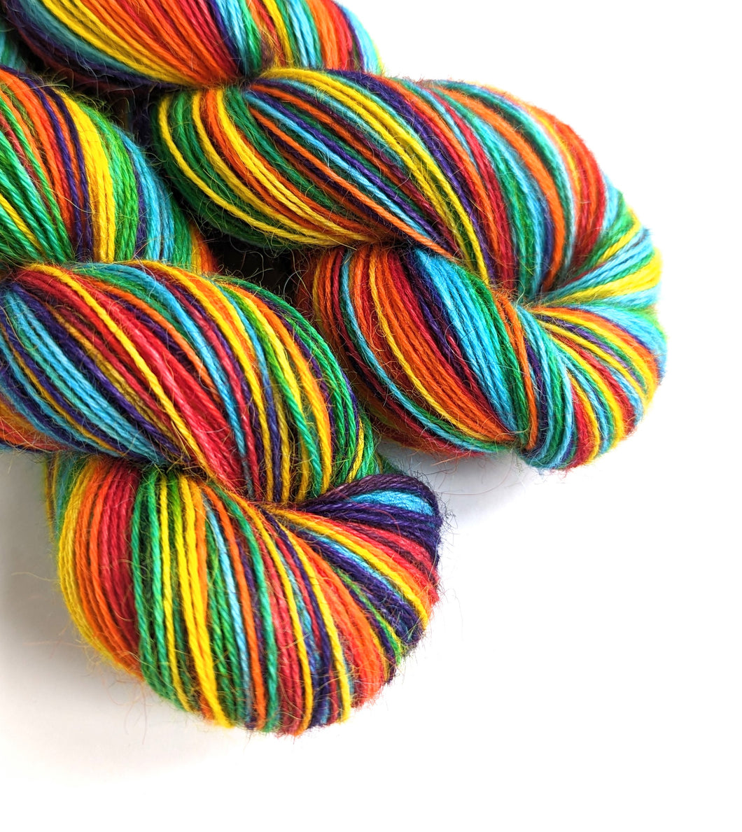 Rainbow on 100% llama 4ply/fingering weight yarn. Natural base.